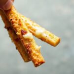 Golden cheesy garlic breadsticks, a delicious baked delight.