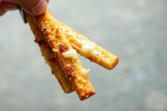 Golden cheesy garlic breadsticks, a delicious baked delight.