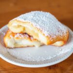 Beignets Uncovered: Deliciously rich, iconic doughy delight explored.