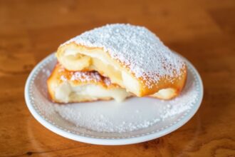 Beignets Uncovered: Deliciously rich, iconic doughy delight explored.