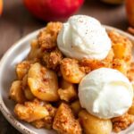 Cozy up with warm, gluten-free slow cooker apple crisp delight.