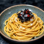 Dive luxury: Squid ink pasta, caviar delight, opulent seafood.