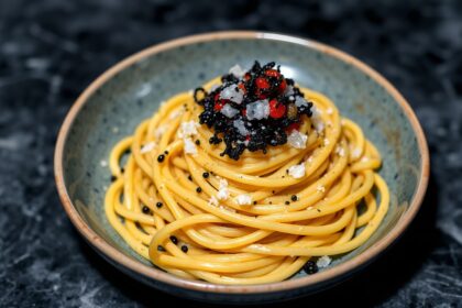 Dive luxury: Squid ink pasta, caviar delight, opulent seafood.