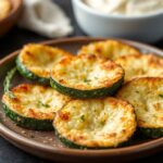 Crispy baked parmesan zucchini rounds, savory snack delight.