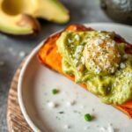 Indulgent sweet potato toast with creamy avocado and flaky salt.