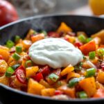 Colorful sweet potato hash with vibrant bell peppers and onions.