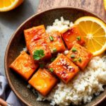 Sticky orange tofu: Zesty plant-based delight for a delicious meal.