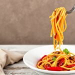 Discover bold flavors: roasted red pepper pasta delight.