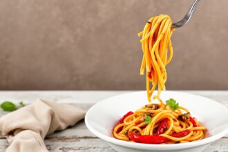 Discover bold flavors: roasted red pepper pasta delight.