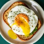 Elevate breakfast: Pesto eggs perfection on sourdough toast.