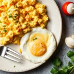 Dreamy cheesy scrambled eggs, rich, velvety, and indulgent breakfast.