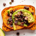 Sweet potato toast topped with creamy avocado for a healthy twist.