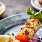 Grilled swordfish skewers with colorful peppers and onions.