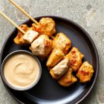 Savor flavors: Delicious chicken satay with creamy peanut sauce.